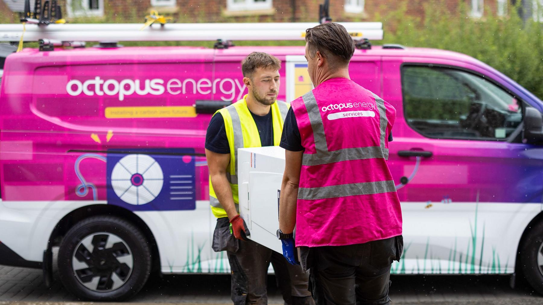 Octopus energy van and two Octopus energy employees carrying a boiler 