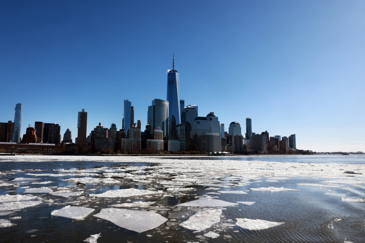 Ice floats cover parts of the Hudson River in front of the Manhattan skyline, including One World Trade Center.